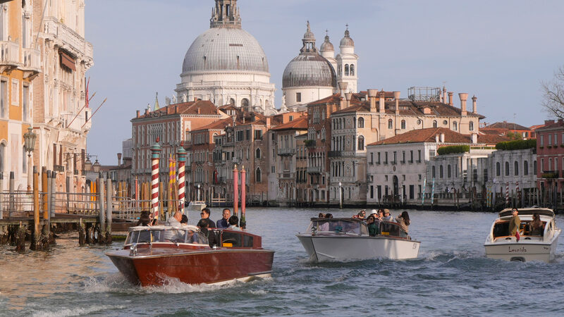 Beyond Sightseeing : Shared water taxis gliding under Accademia Bridge