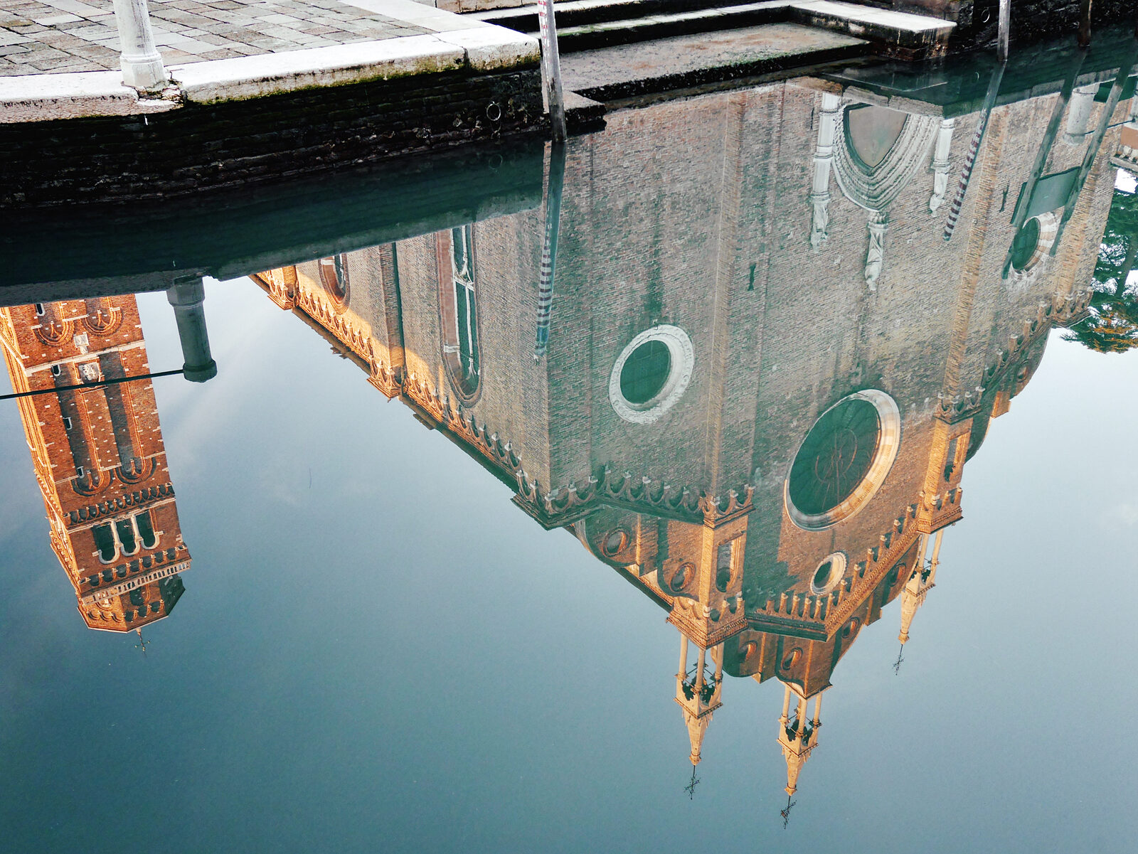 Basilica dei Frari : A spectacular reflection of the facade in a nearby canal