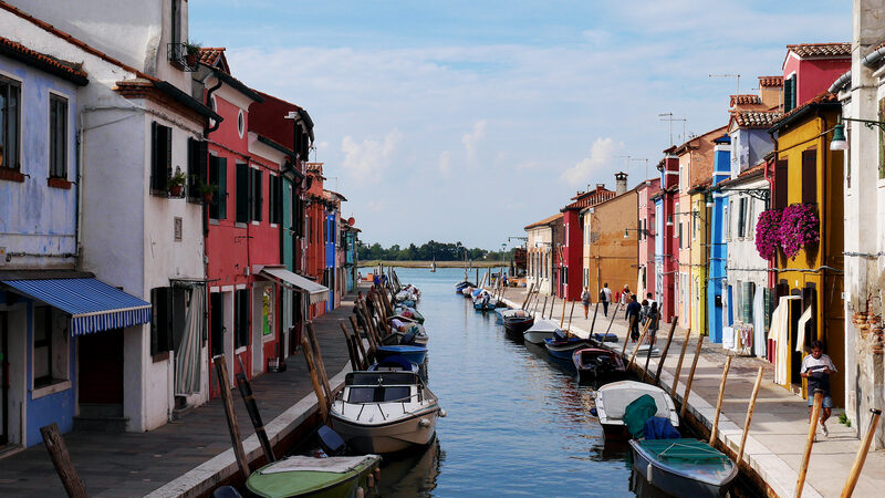 Burano : A quaint canal lined with colorful houses and small boats