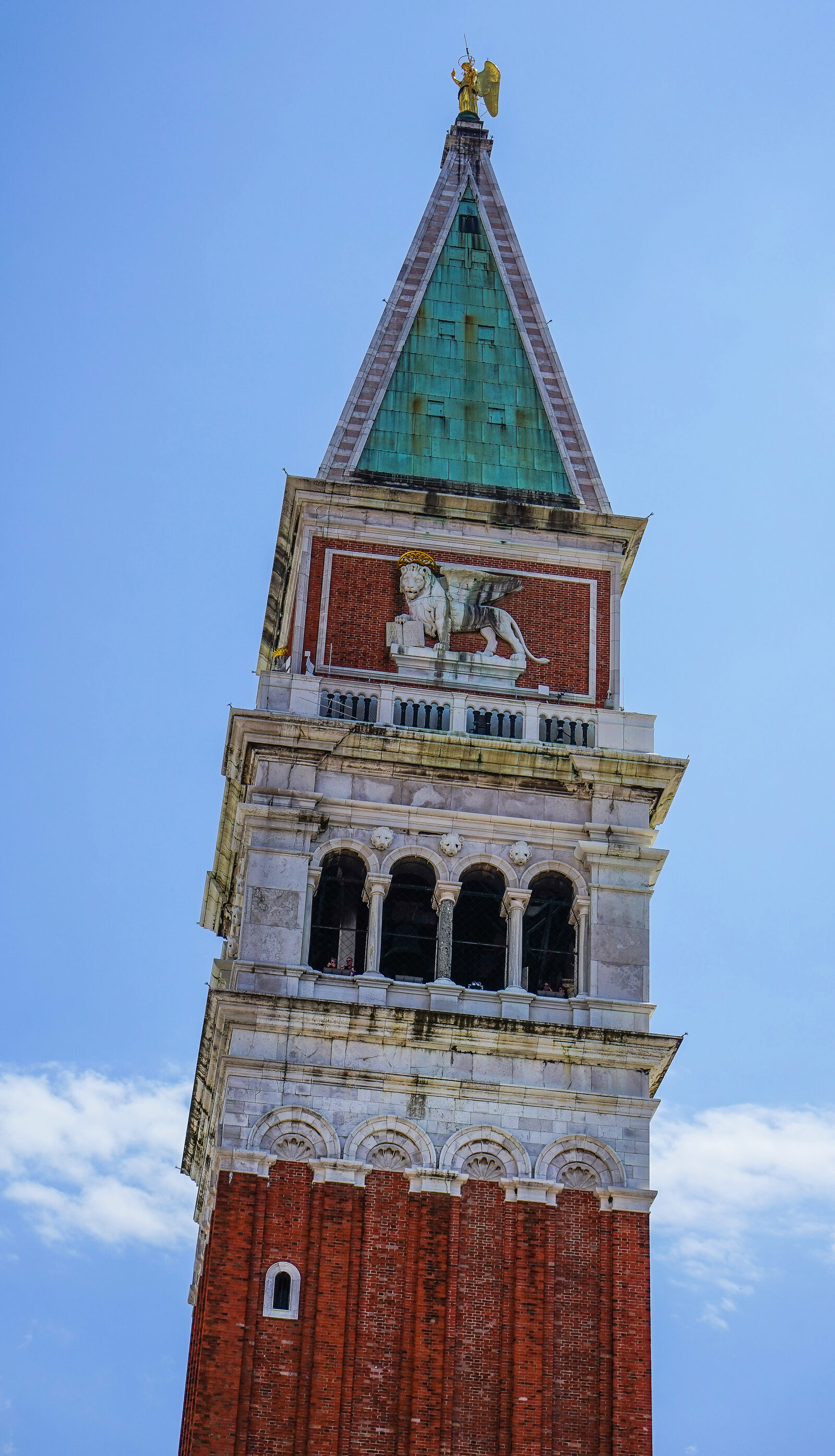 Campanile di San Marco : The top of the tower features the belfry (where you can climb), the symbol of St. Mark and a pyramidal spire topped by a golden angel
