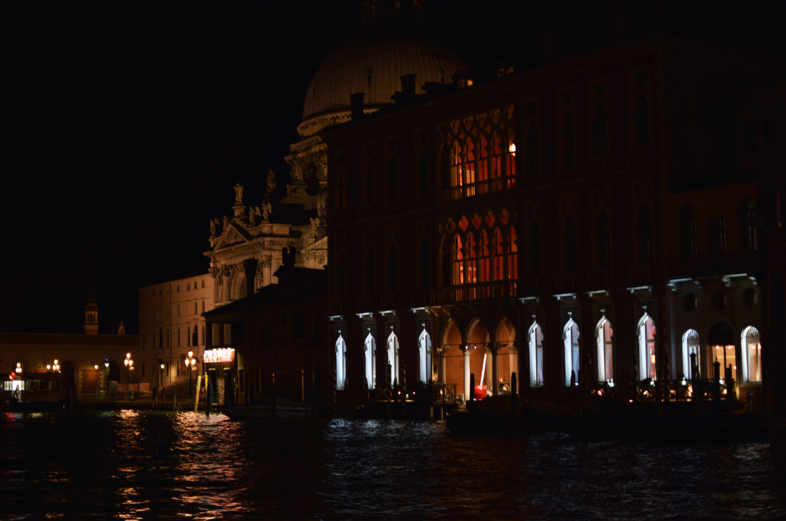 Grand Canal : Behind the illuminated palaces rises the massive silhouette of Santa Maria della Salute