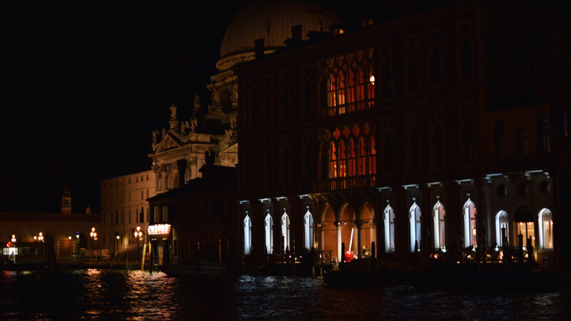 Grand Canal : Behind the illuminated palaces rises the massive silhouette of Santa Maria della Salute