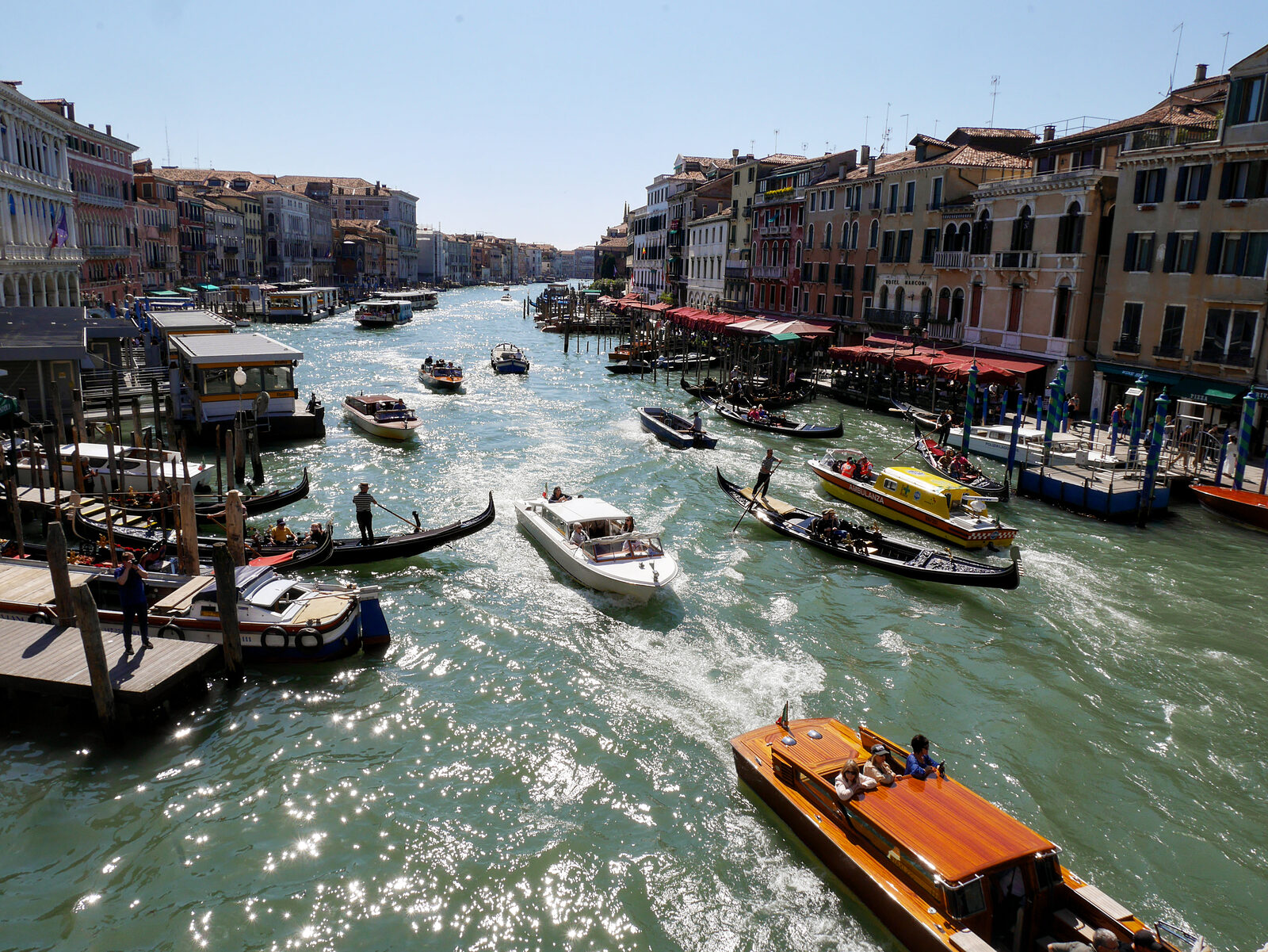 Rialto Bridge : Fast-forward to a summer day, and this is the usual boat traffic passing under the bridge