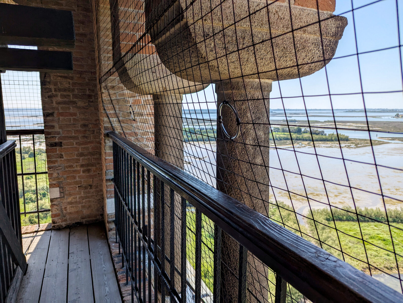 Torcello Campanile : Finally at the top, it’s reassuring to know a protective net is in place for safety, though many visitors mention it can make photographing a bit tricky