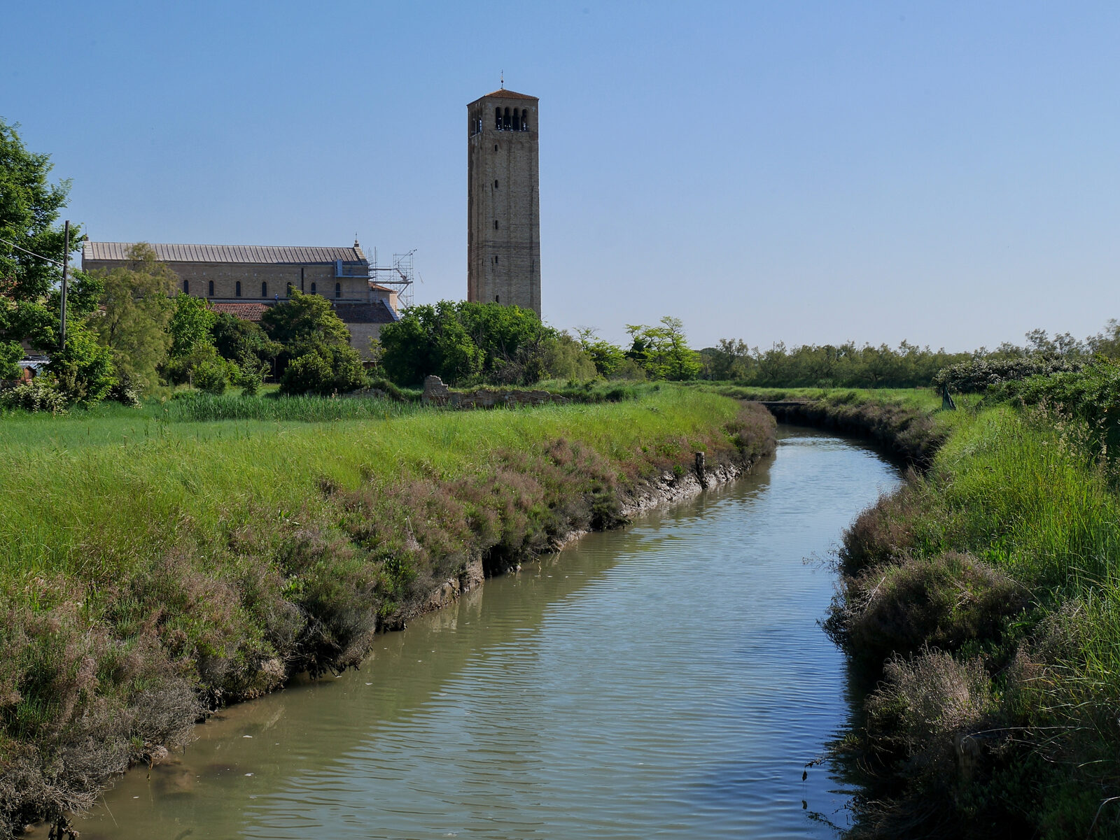 Torcello Campanile : Beyond the parent church Santa Maria Assunta, the tower is surrounded by open greenery and swampy terrain as far as the eye can see