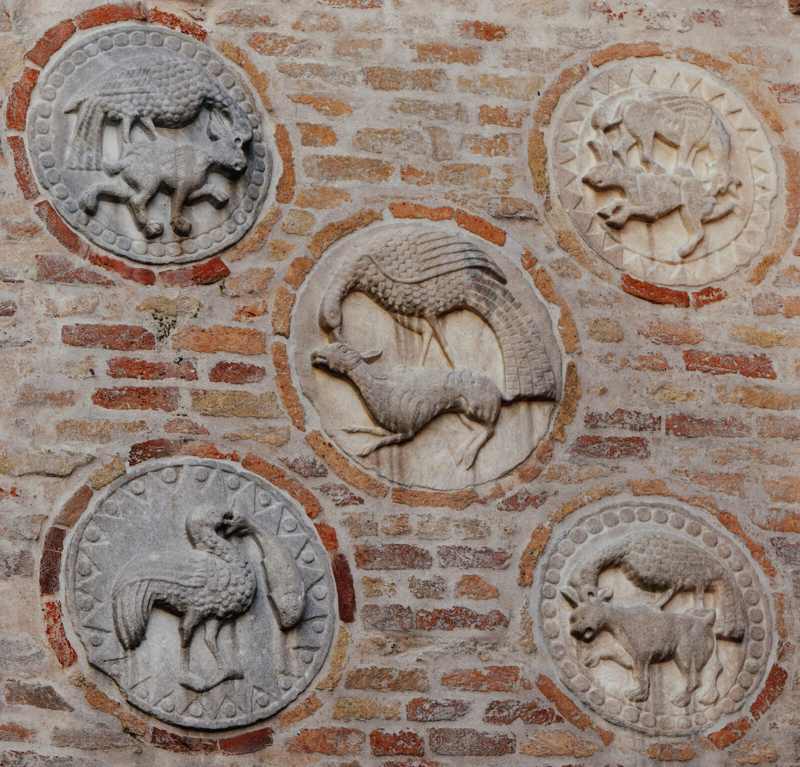 Santa Maria dei Carmini : The five pateras on the top of the side entrance: medieval symbols of the struggle between good an evil