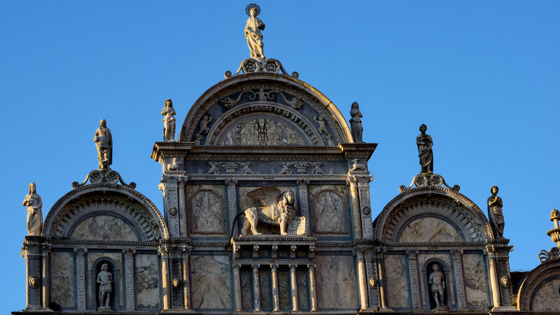Scuola Grande di San Marco : The facade features many marble statues of angels, warriors, and other fantastical creatures
