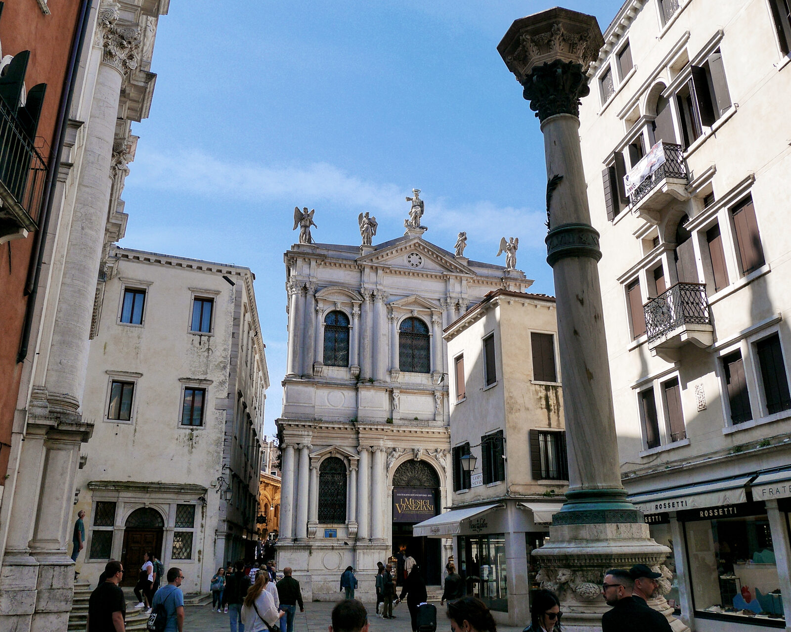 Scuola Grande di San Teodoro : Stepping back a bit in the campo and the statues atop become visible: Saint Theodore in the center and adoring angels on the sides