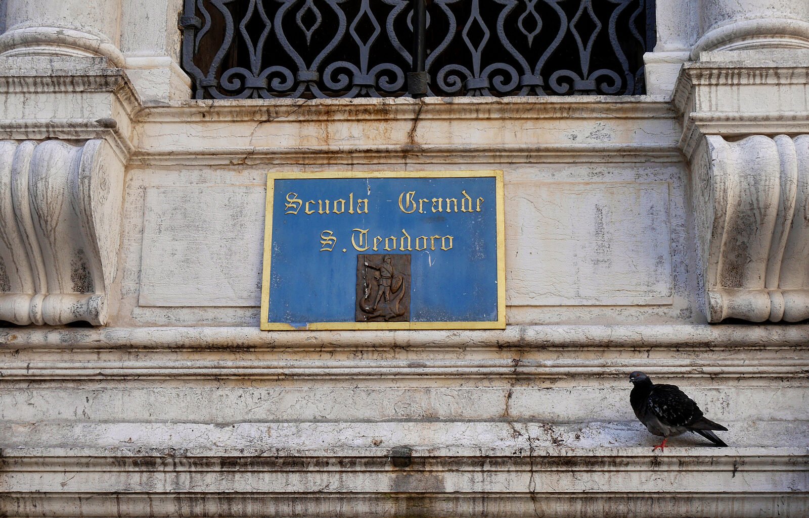 Scuola Grande San Teodoro : To the left of the entrance is the Scuola's name and a small bronze bas-relief depicting the patron saint defeating the dragon