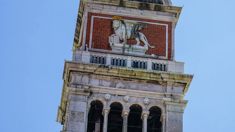 San Marco Campanile : The top of the tower features the belfry (where you can climb), the symbol of St. Mark and a pyramidal spire topped by a golden angel