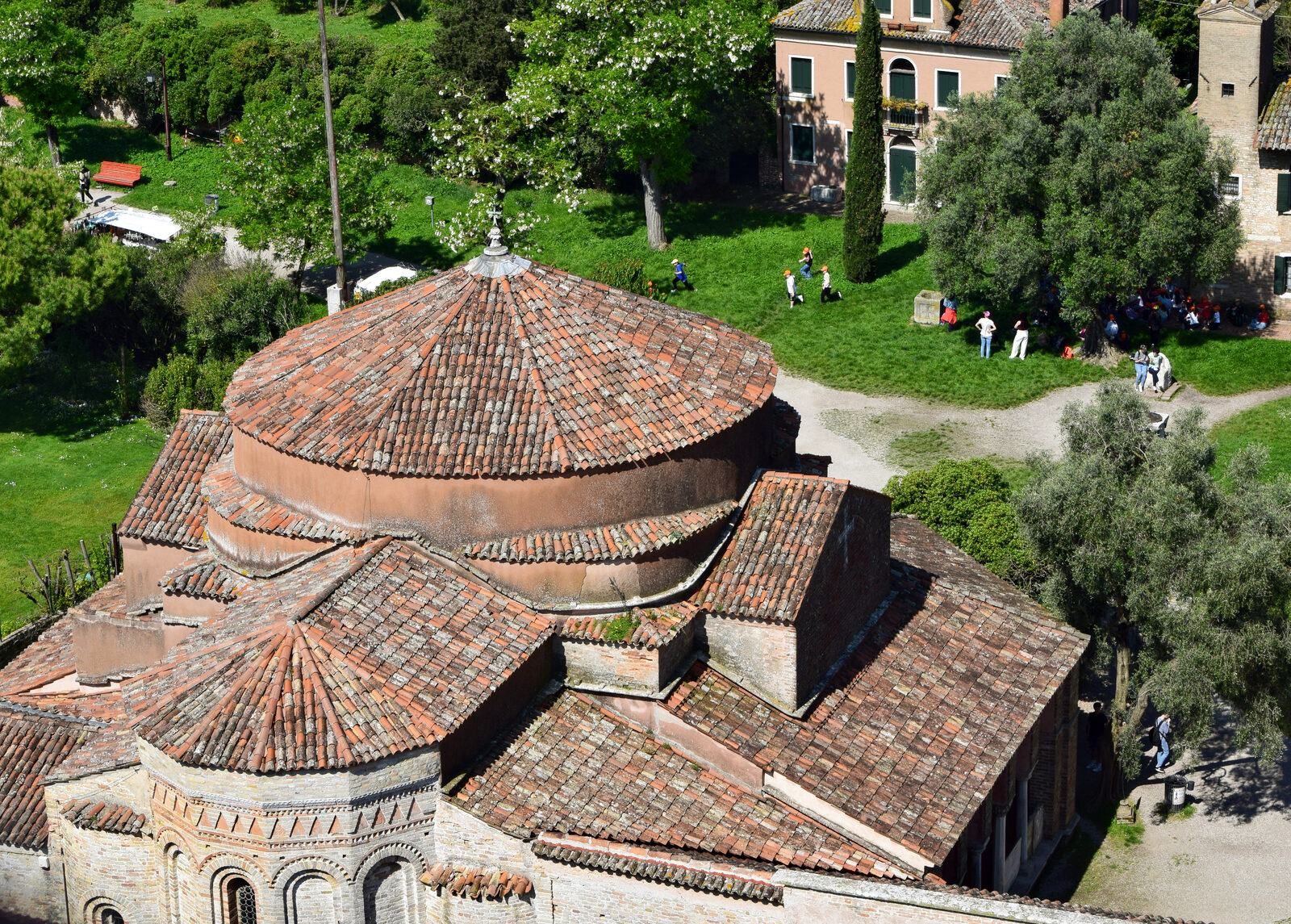 Torcello Belltower : And shifting the view even closer to the base of the tower, people appear tiny in what was once the bustling center of Torcello