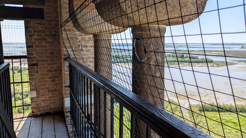 Torcello Belltower : Finally at the top, it’s reassuring to know a protective net is in place for safety, though many visitors mention it can make photographing a bit tricky